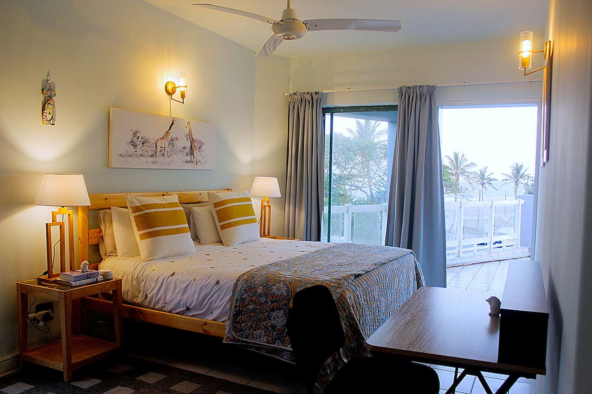 Master bedroom opening onto a sea-view balcony